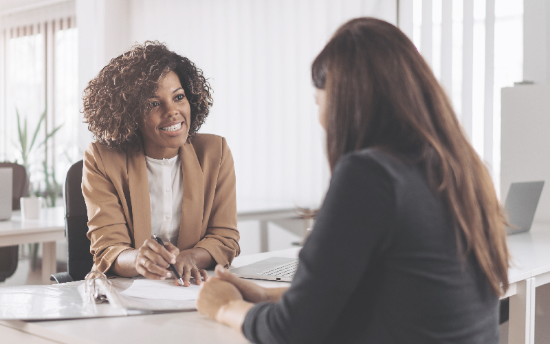 Two women discussing business at a table
