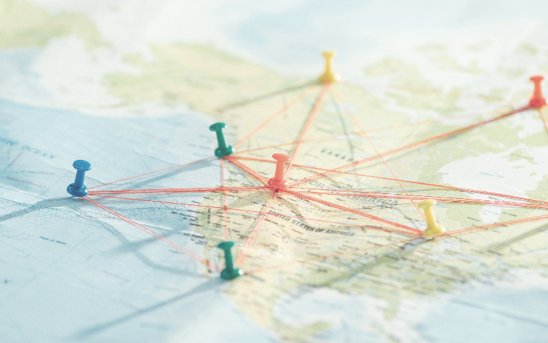 Map with push pins and string